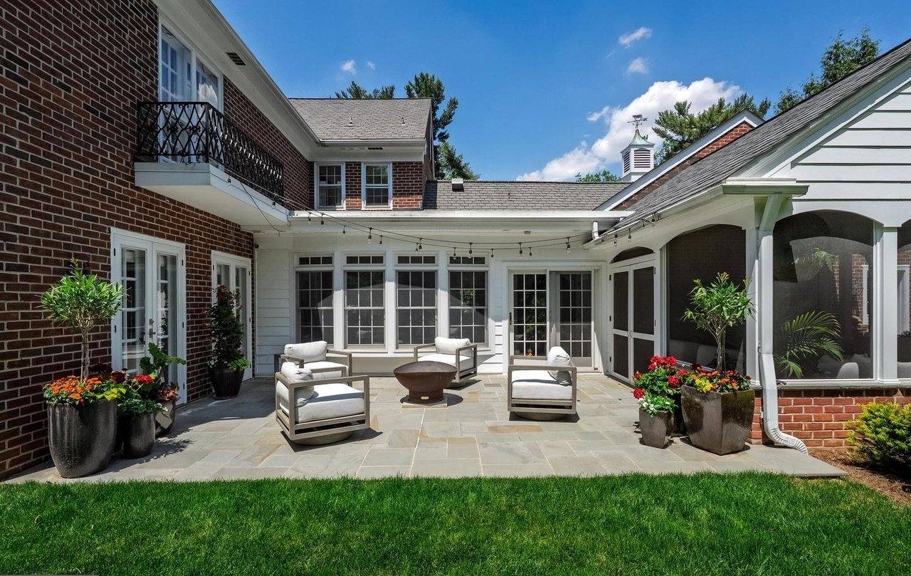 Rear courtyard with a bluestone terrace, outdoor seating and planters